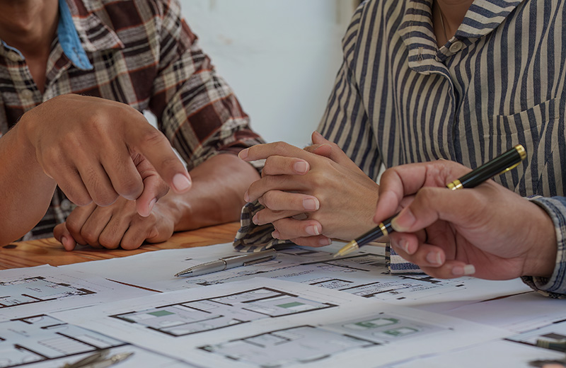 Professional architect designer structural engineer team colleagues discussing building plan design project